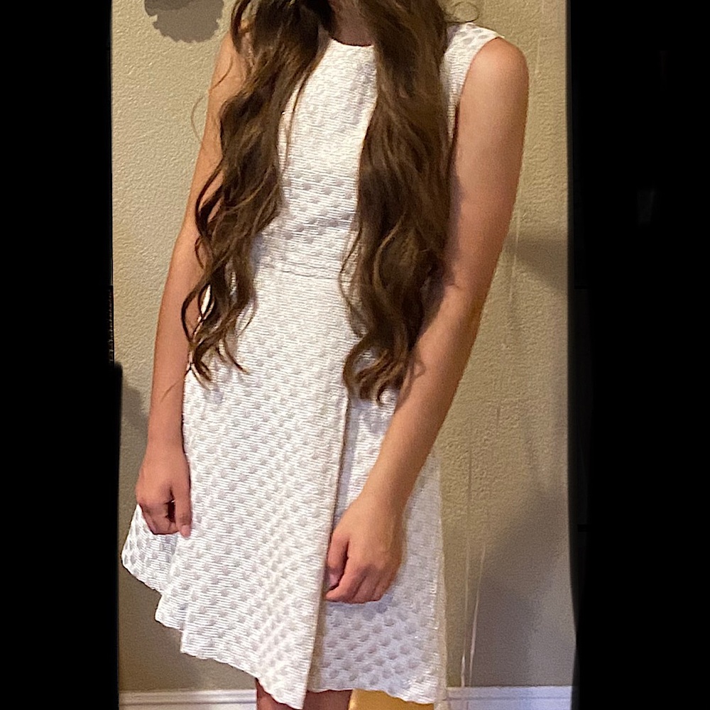 White sleeveless dress with gold polka dots